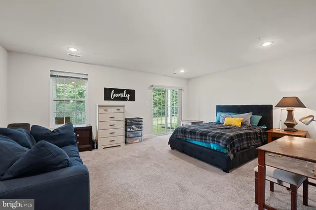 a spacious bedroom with a bed and furniture