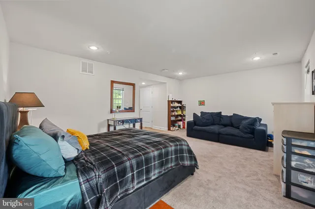 a bedroom with a bed and a couch