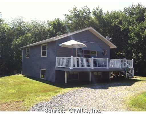 25 Holly Road Wakefield, RI 02879 - Photo 1 of 1 a view of a house with a backyard patio and backyard