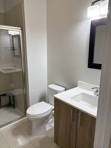 a bathroom with a sink toilet and mirror