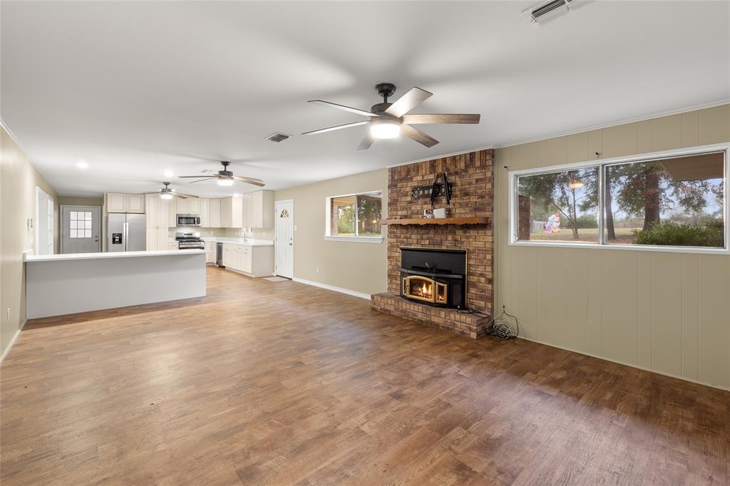 1621 Baseball Loop Diana, TX 75640 - Photo 11 of 38 a view of a livingroom with furniture a ceiling fan and window