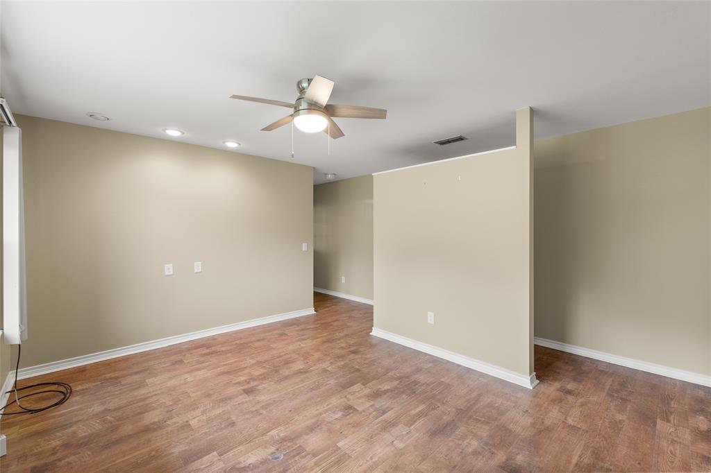 1621 Baseball Loop Diana, TX 75640 - Photo 14 of 38 an empty room with a ceiling fan and a window