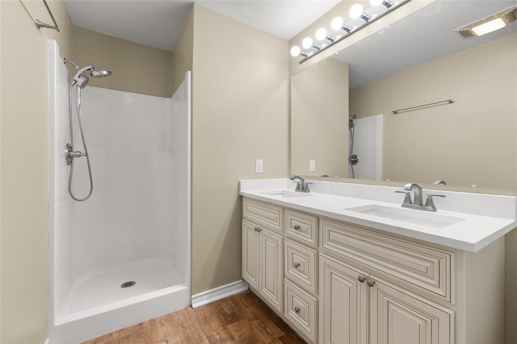 1621 Baseball Loop Diana, TX 75640 - Photo 17 of 38 a bathroom with a double vanity sink mirror and shower