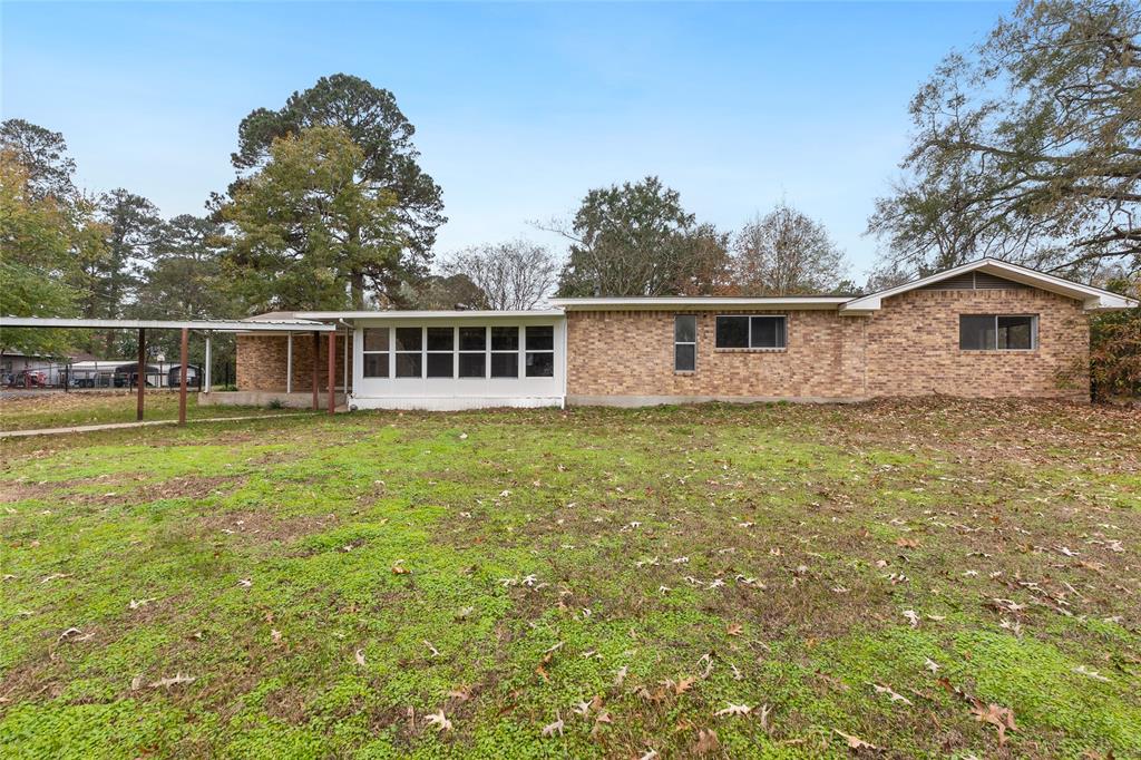 1621 Baseball Loop Diana, TX 75640 - Photo 35 of 38 a view of a house with a yard and trees