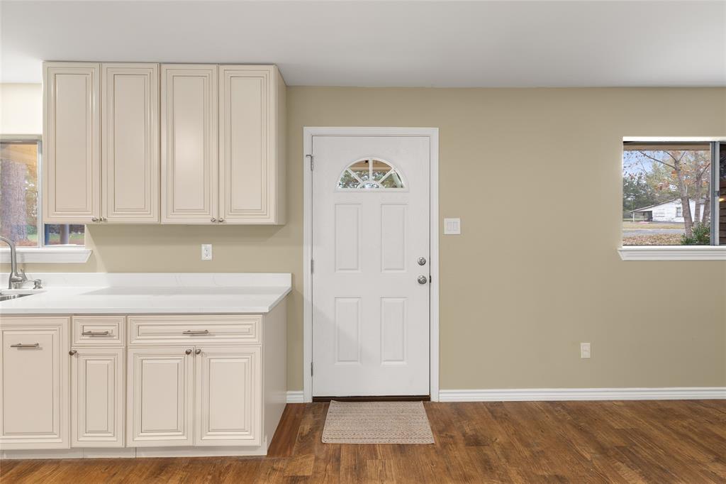1621 Baseball Loop Diana, TX 75640 - Photo 4 of 38 an empty room with wooden floor and cabinet