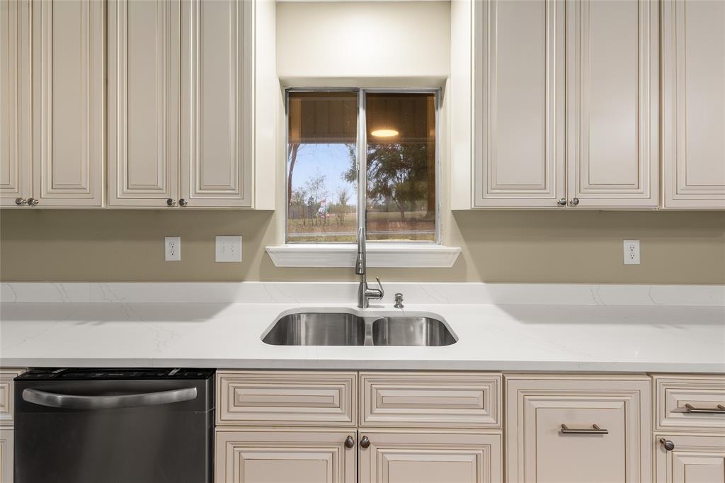 1621 Baseball Loop Diana, TX 75640 - Photo 7 of 38 a kitchen with stainless steel appliances granite countertop a sink and a white cabinets