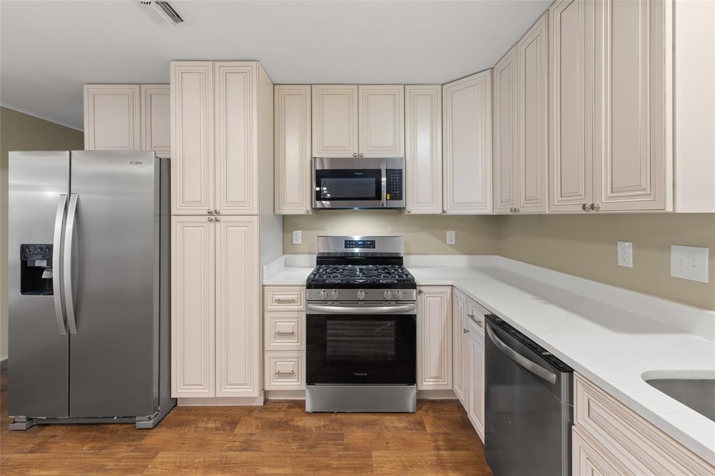 1621 Baseball Loop Diana, TX 75640 - Photo 8 of 38 a kitchen with refrigerator stove and cabinets