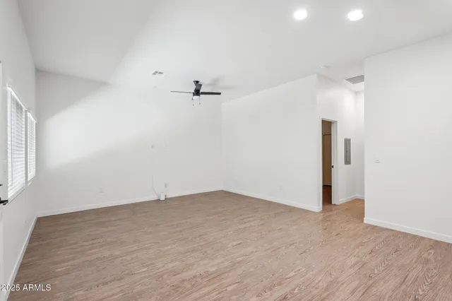 an empty room with a empty space and windows