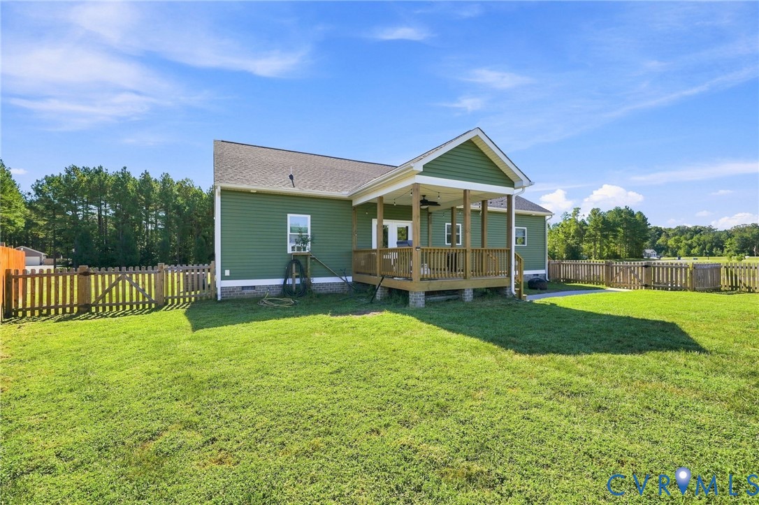 8718 Rock Cedar Road New Kent, VA 23124 - Photo 35 of 43 Expansive green lawn, covered rear porch, wood pic