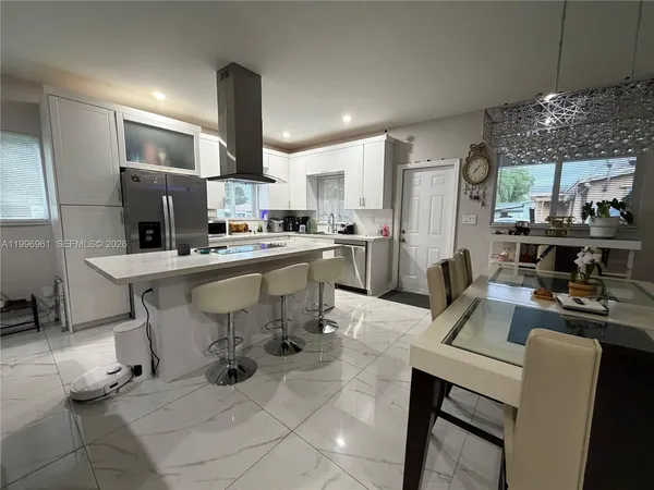 a kitchen with a sink stainless steel appliances and cabinets