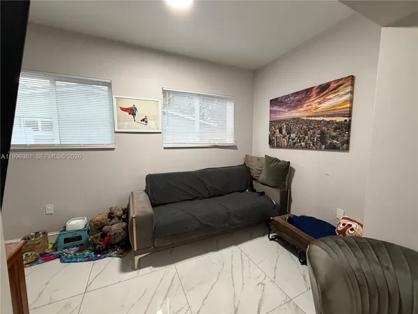 a living room with furniture and a window