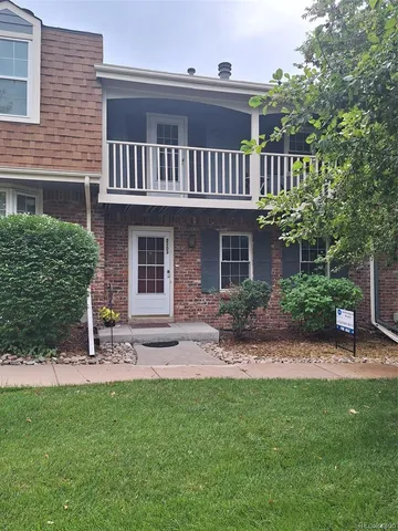 a view of a house with a yard and sitting area