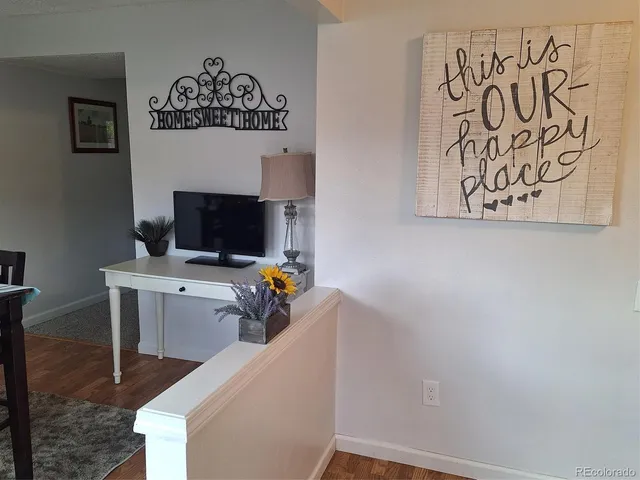 a view of a workspace with furniture and a fireplace