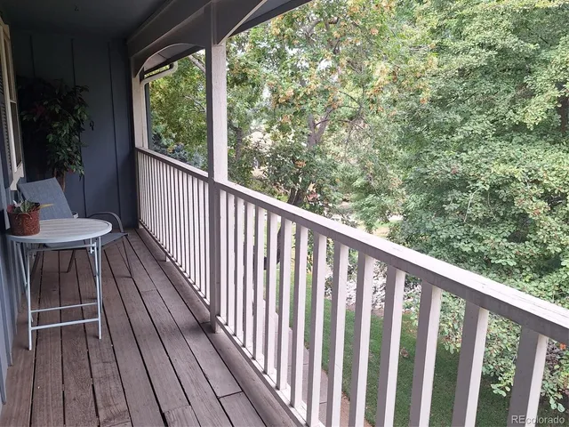 a balcony with wooden floor and outdoor space