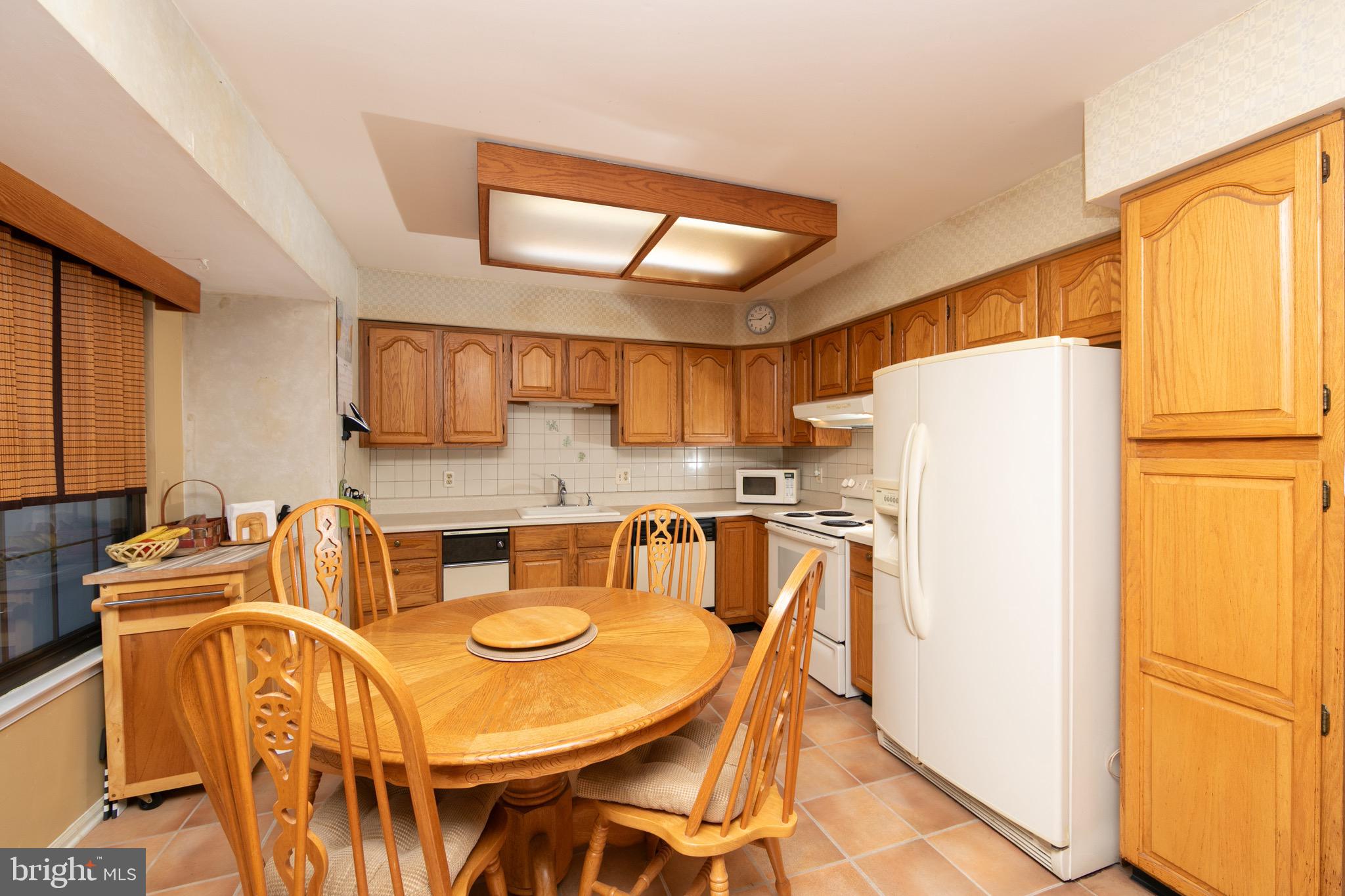 1 Crofton Commons Cherry Hill, NJ 08034 - Photo 12 of 40 a kitchen with stainless steel appliances a refrigerator a sink a dining table and chairs