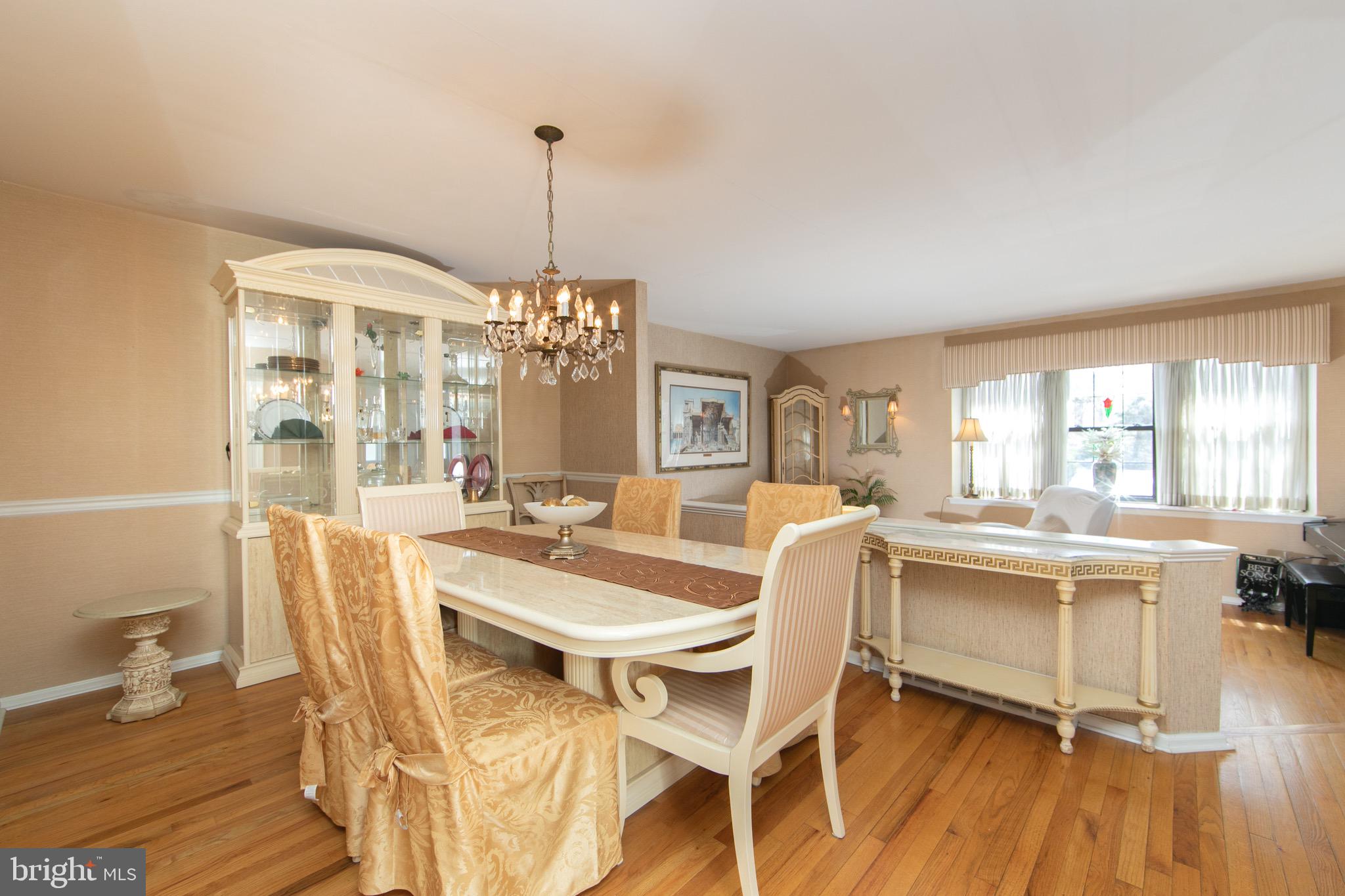 1 Crofton Commons Cherry Hill, NJ 08034 - Photo 7 of 40 a dining room with furniture window wooden floor and a chandelier