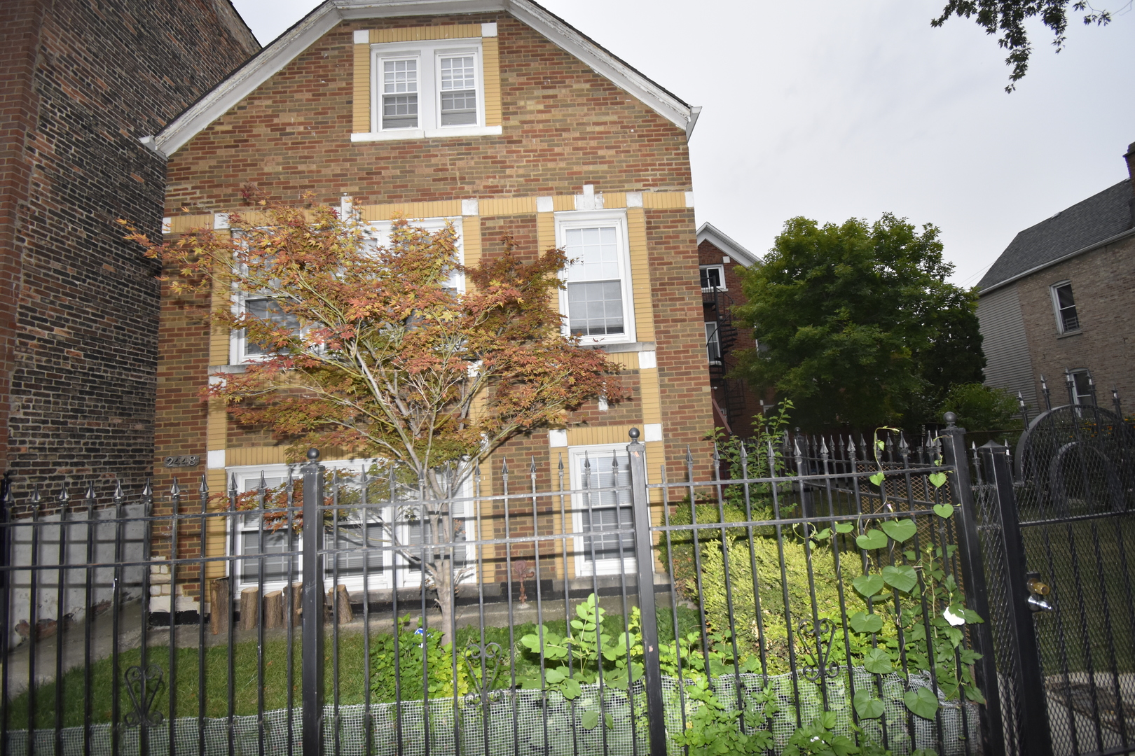a front view of a house with a garden