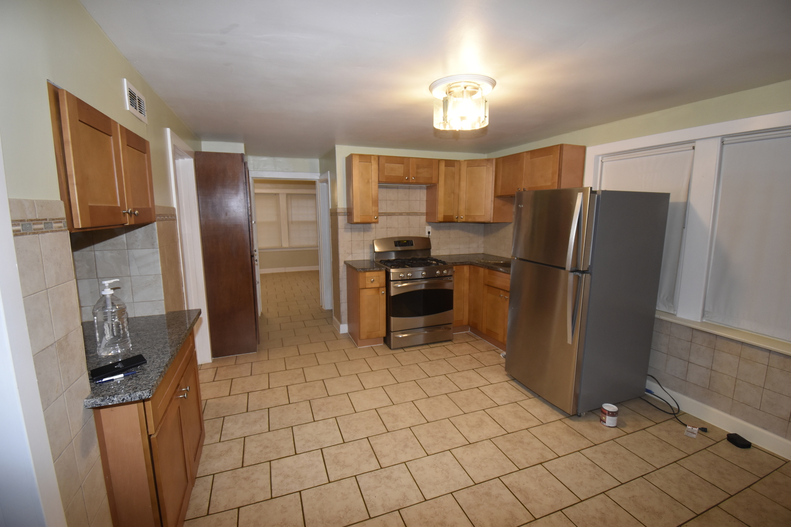 2448 South Homan Avenue, Unit 1 Chicago, IL 60623 - Photo 7 of 12 a kitchen with granite countertop a refrigerator and a sink