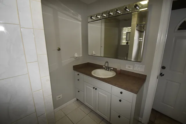 a bathroom with a sink and mirror