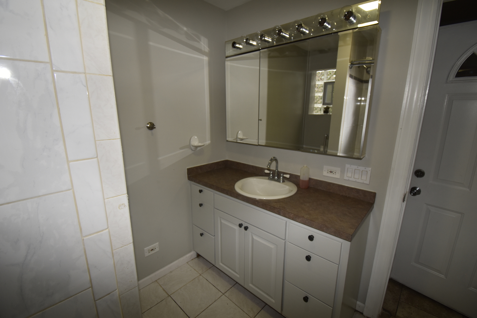 2448 South Homan Avenue, Unit 1 Chicago, IL 60623 - Photo 9 of 12 a bathroom with a sink and mirror