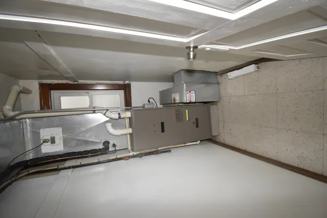 a room with stainless steel appliances a sink and a stove