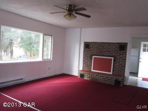 167 Independence Road East Stroudsburg, PA 18301 - Photo 7 of 11 a living room with a fireplace and a window