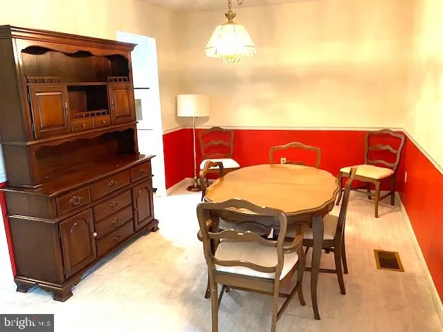 a view of a dining room with furniture and a flat screen tv