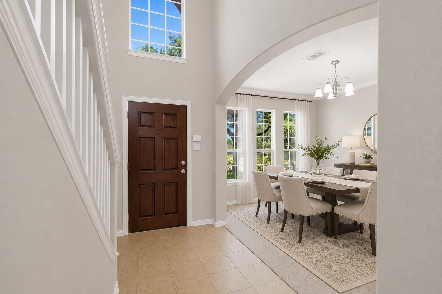 25926 Morgan Springs Spring, TX 77373 - Photo 4 of 49 Step inside to a dramatic two-story foyer featuring soaring ceilings, abundant natural light, elegant large tile flooring, and graceful archways. The formal dining room is perfectly positioned just off the entry, creating a welcoming space for entertaining family and friends. **Photo is Virtually Staged**