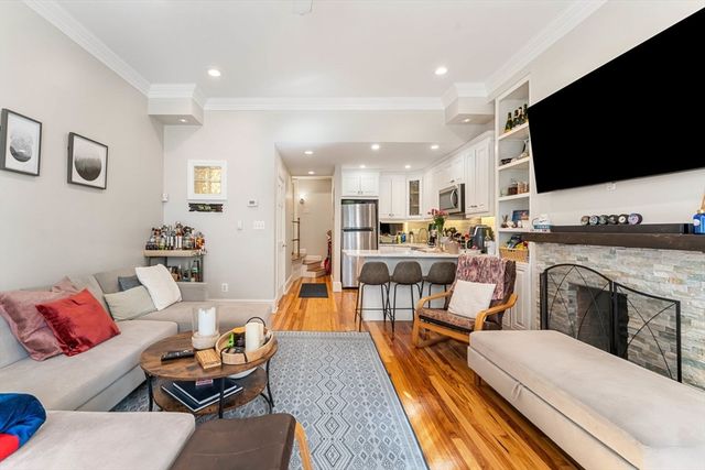 a living room with fireplace furniture and a flat screen tv