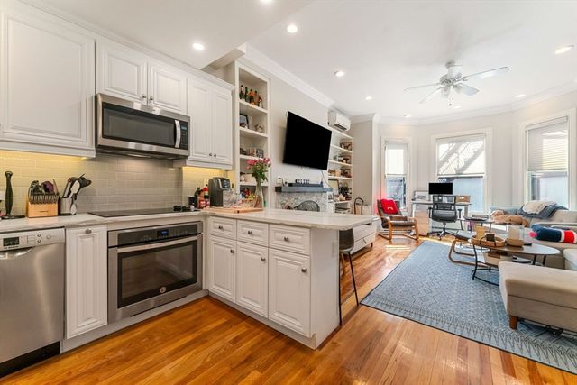 a kitchen with stainless steel appliances a stove a sink and a microwave