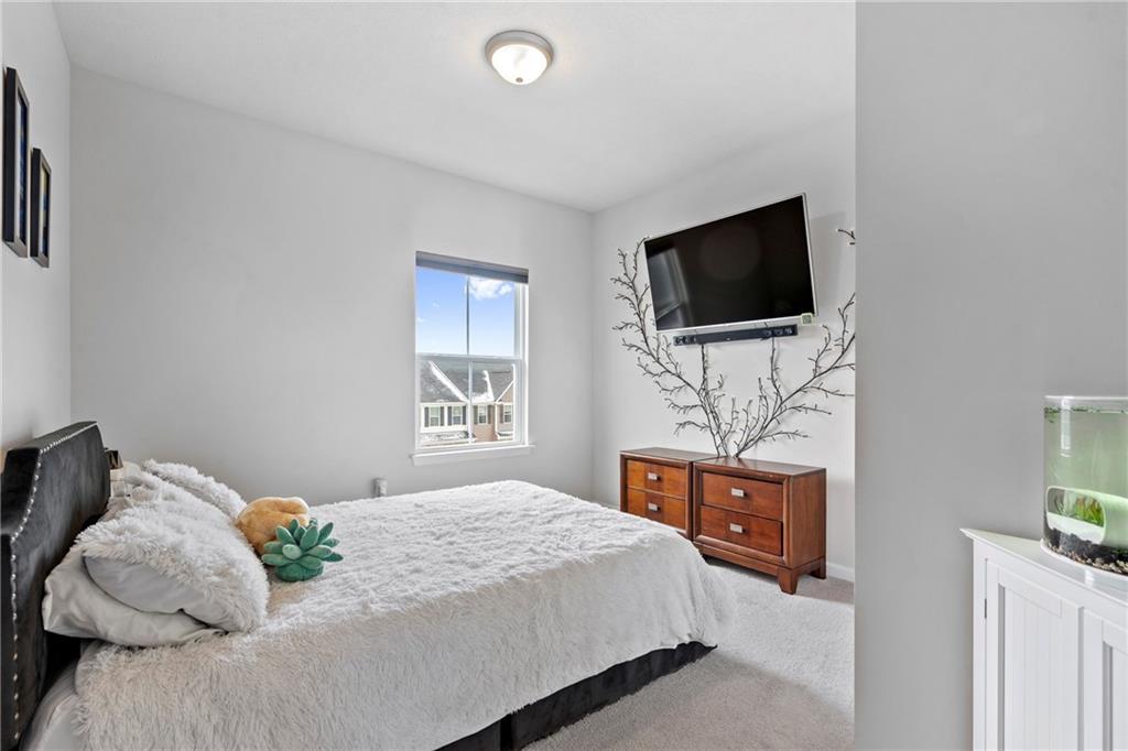 327 Helenium Drive Mars, PA 16046 - Photo 20 of 35 a bedroom with a bed a television and wooden floor