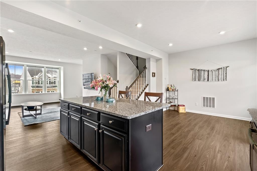 327 Helenium Drive Mars, PA 16046 - Photo 8 of 35 a kitchen with stainless steel appliances granite countertop a sink stove and wooden floor