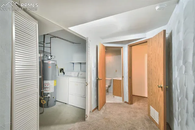 a view of a kitchen with a sink and refrigerator