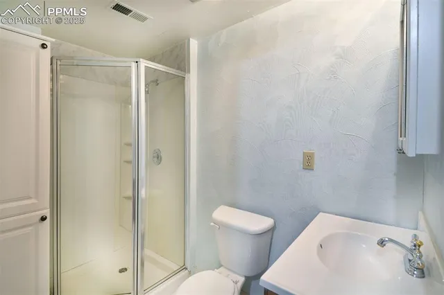 a white toilet sitting next to a bathroom sink