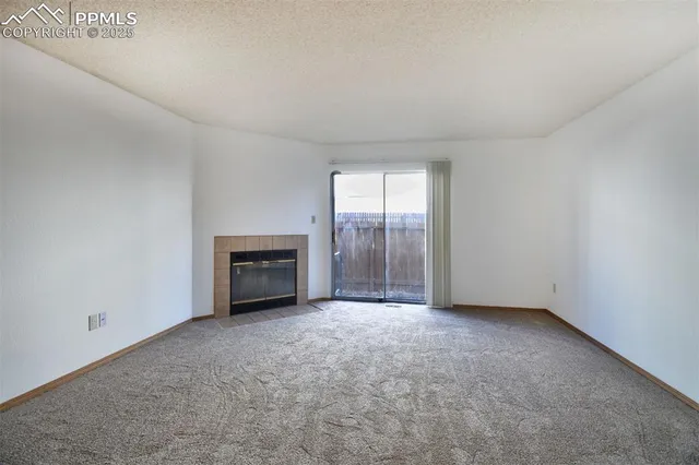 an empty room with floor to ceiling window and an empty room