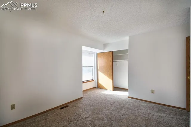 a view of an empty room and a window