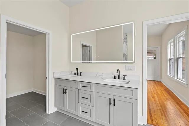 a bathroom with a double vanity sink and mirror