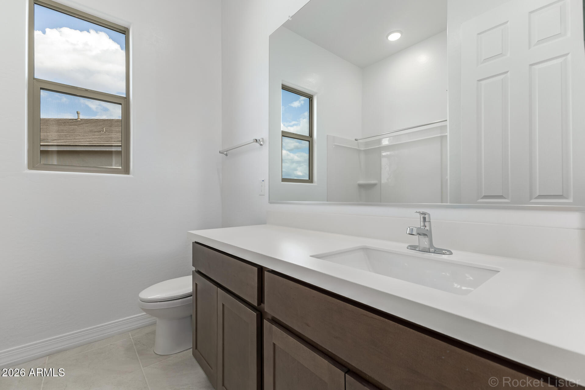 17408 West Via Dona Road Surprise, AZ 85387 - Photo 15 of 17 a bathroom with a granite countertop sink a toilet and a mirror