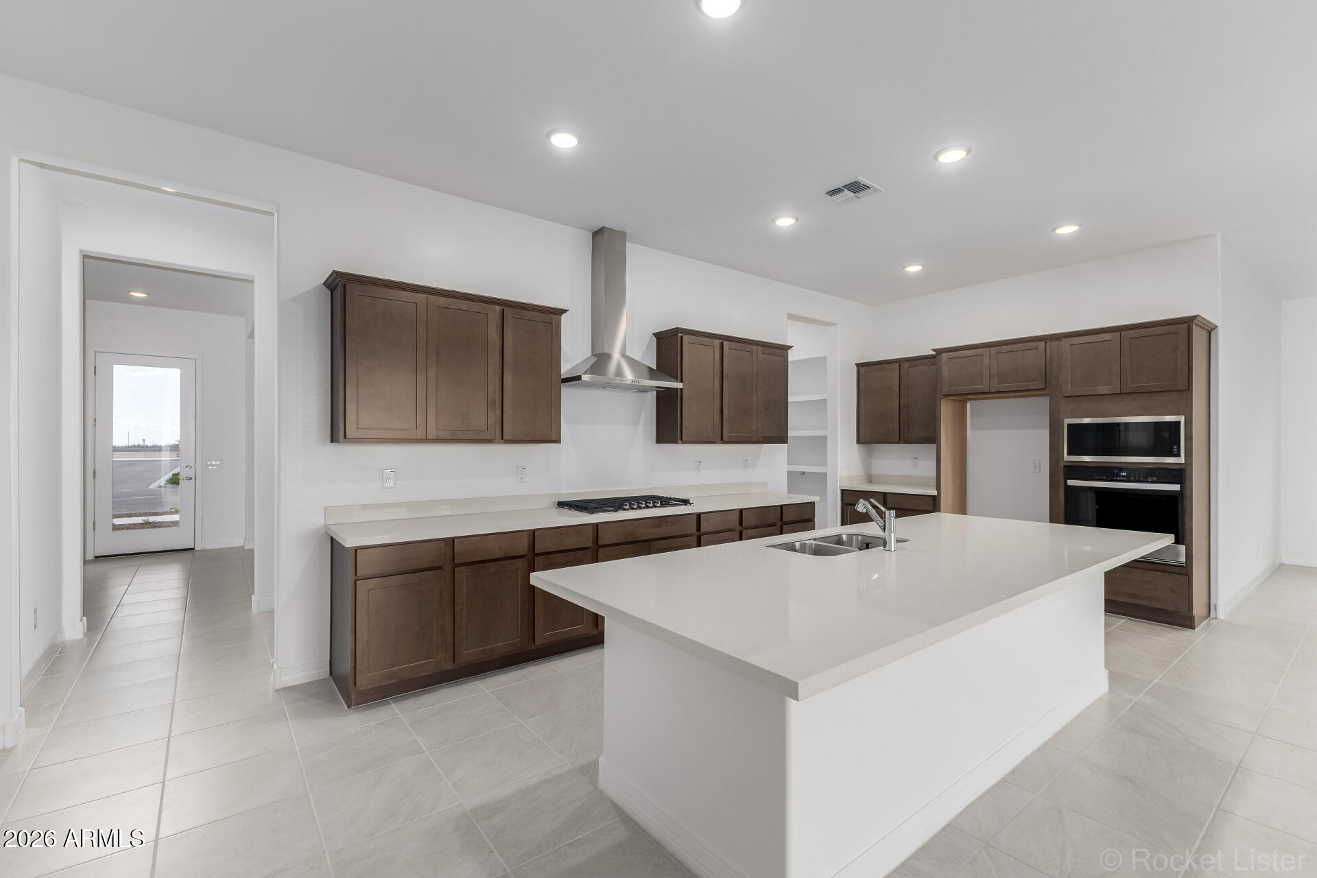 17408 West Via Dona Road Surprise, AZ 85387 - Photo 3 of 17 a large white kitchen with stainless steel appliances