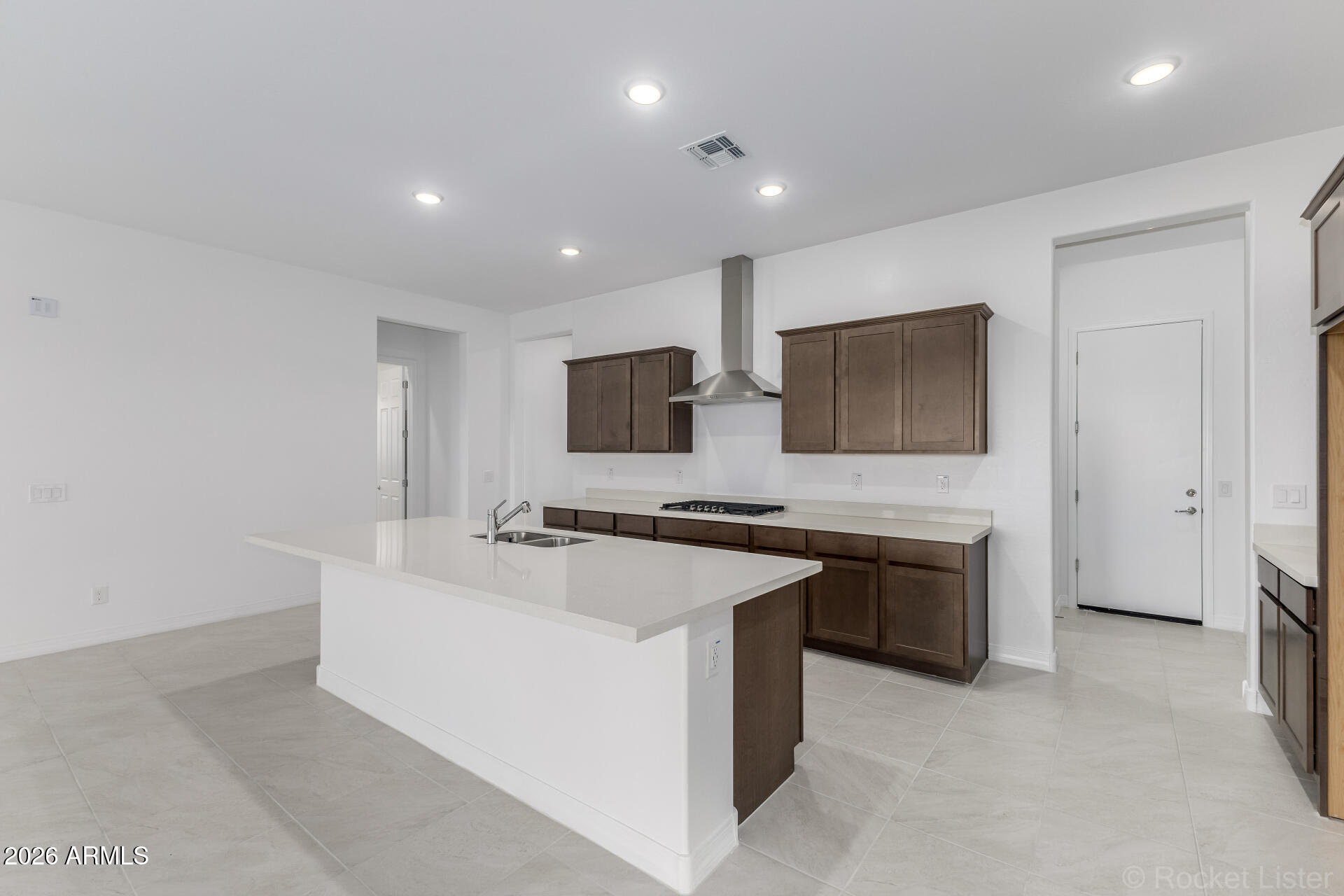 17408 West Via Dona Road Surprise, AZ 85387 - Photo 4 of 17 a large white kitchen with stainless steel appliances granite countertop a stove and a sink