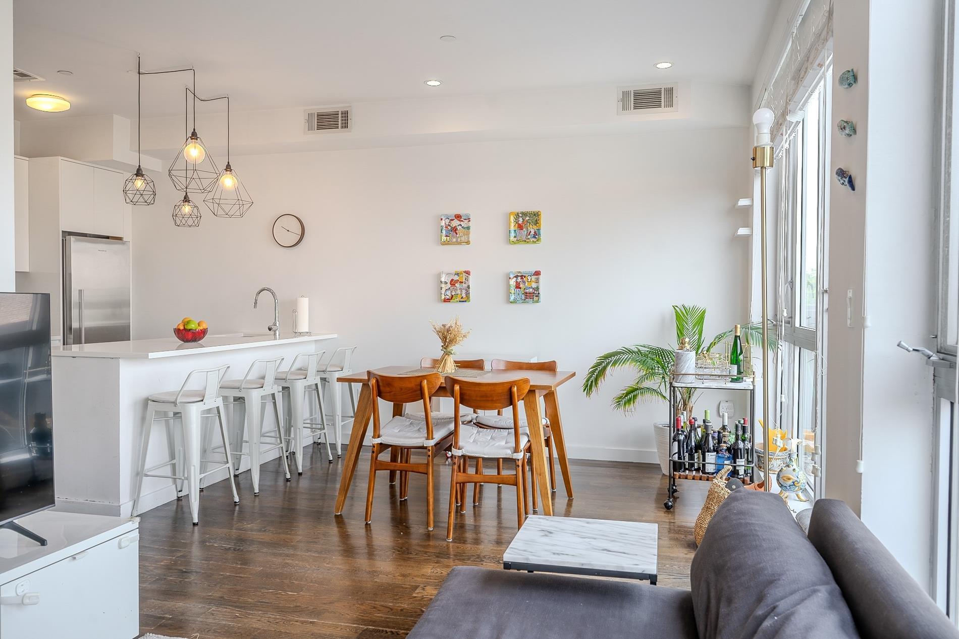 307 Cooper Street Brooklyn, NY 11237 - Photo 1 of 1 a living room with furniture and wooden floor