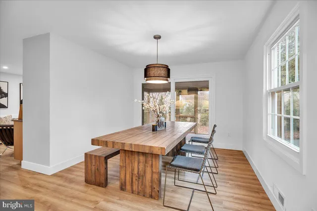 a dining room with a table and chairs