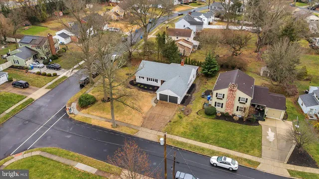 an aerial view of a house with a yard basket ball court and outdoor seating
