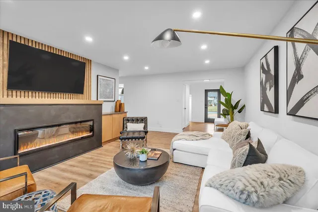 a kitchen with kitchen island wooden cabinets a stove a sink and a window