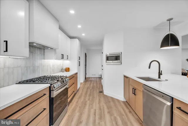 a kitchen with white cabinets and white appliances