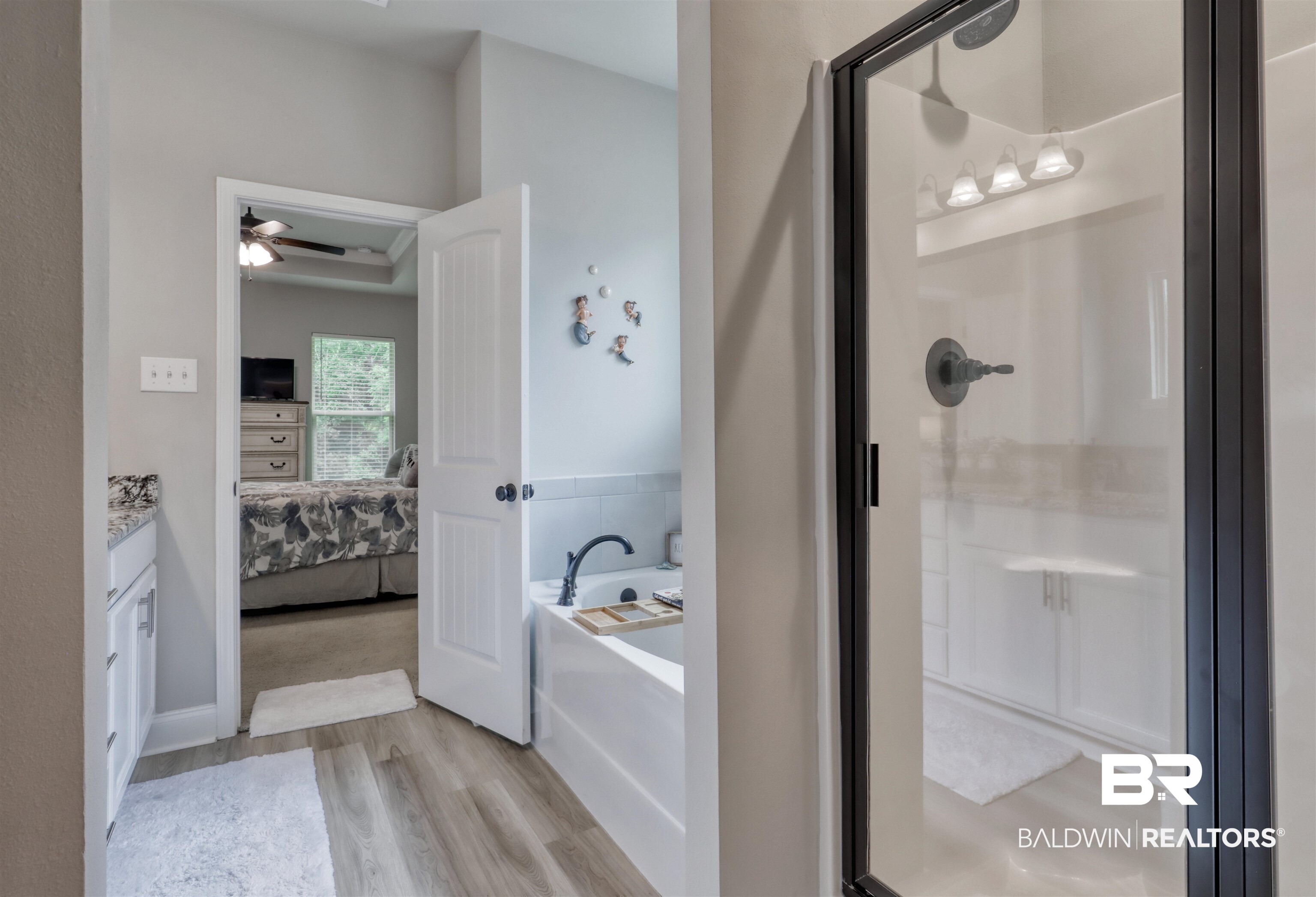 987 Gibson Court Foley, AL 36535 - Photo 19 of 34 Full bathroom with a bath, a shower stall, wood finished floors, and ensuite bathroom