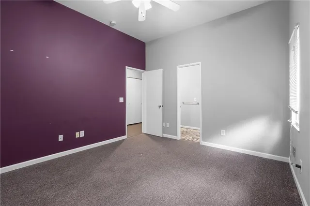 an empty room with a empty space and a ceiling fan
