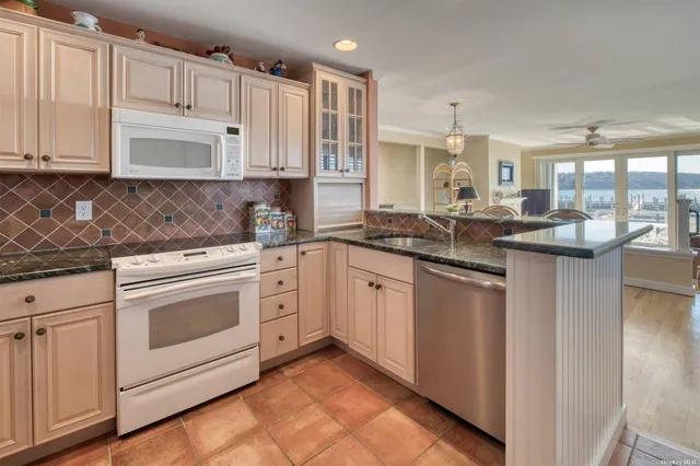 a dining room with wooden floor a chandelier a glass table and chairs