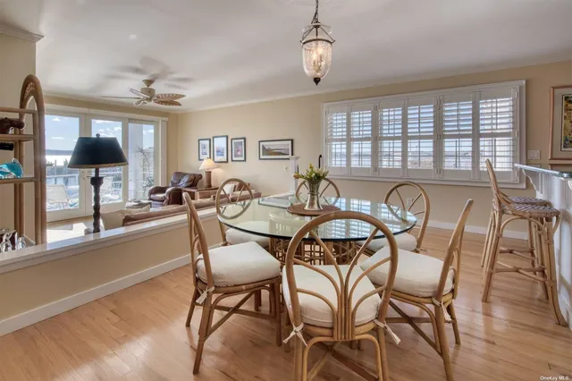 a living room with furniture a fireplace and a floor to ceiling window