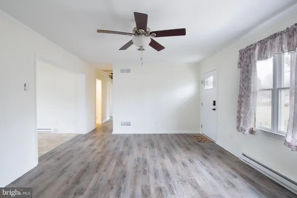 wooden floor in an empty room with a window